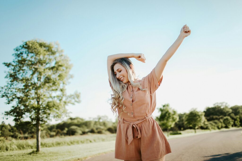 A cheerful woman enjoying a sunny day outdoors in Dayton, Ohio.